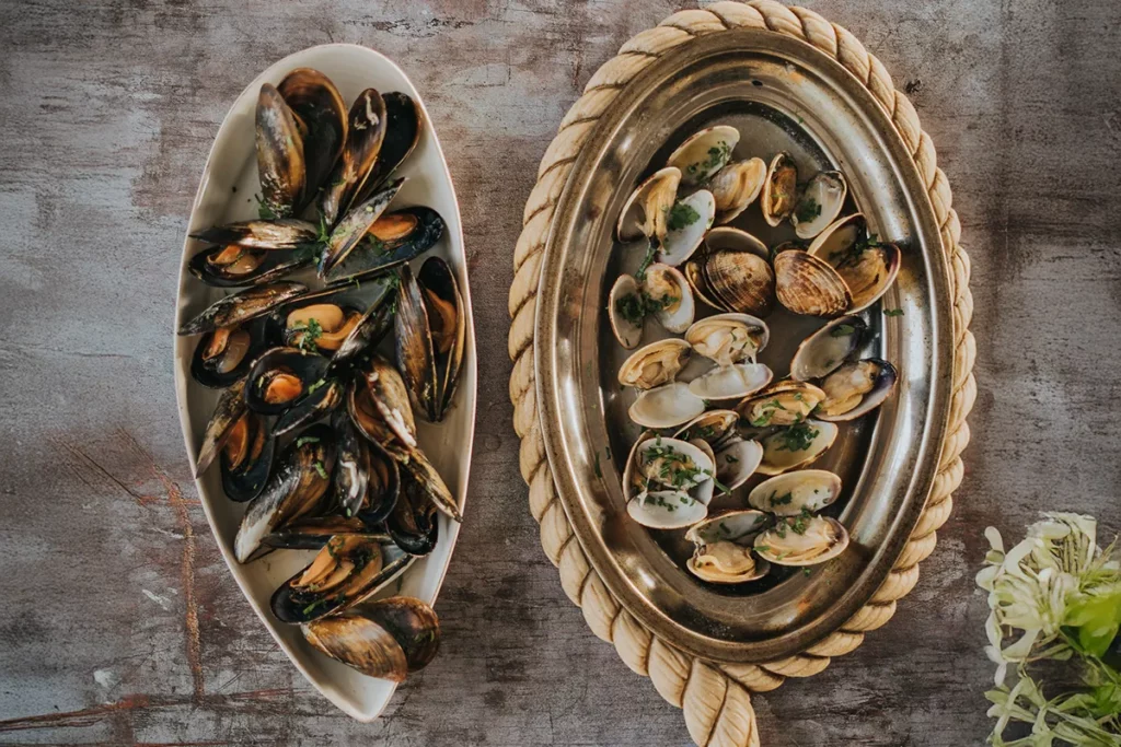 Grilled mussels and clams served on platters